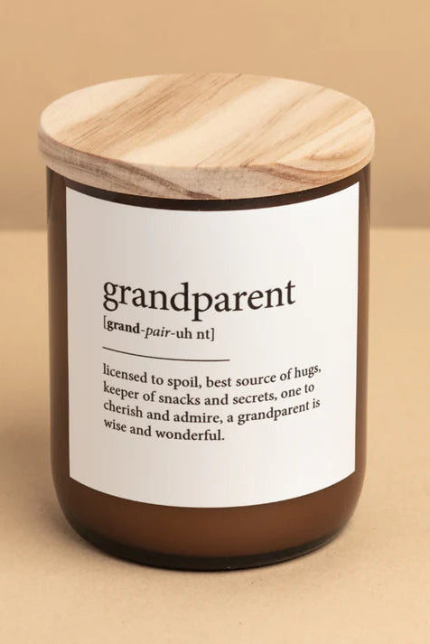 A candle jar with a wooden lid, labeled 'grandparent', set against a neutral background.