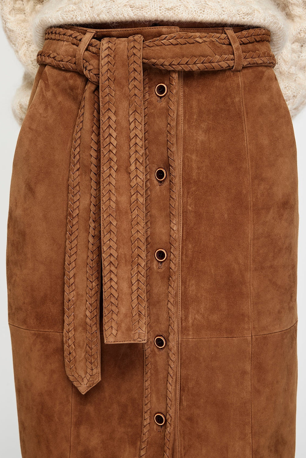 Brown suede skirt with braided belt on a white background