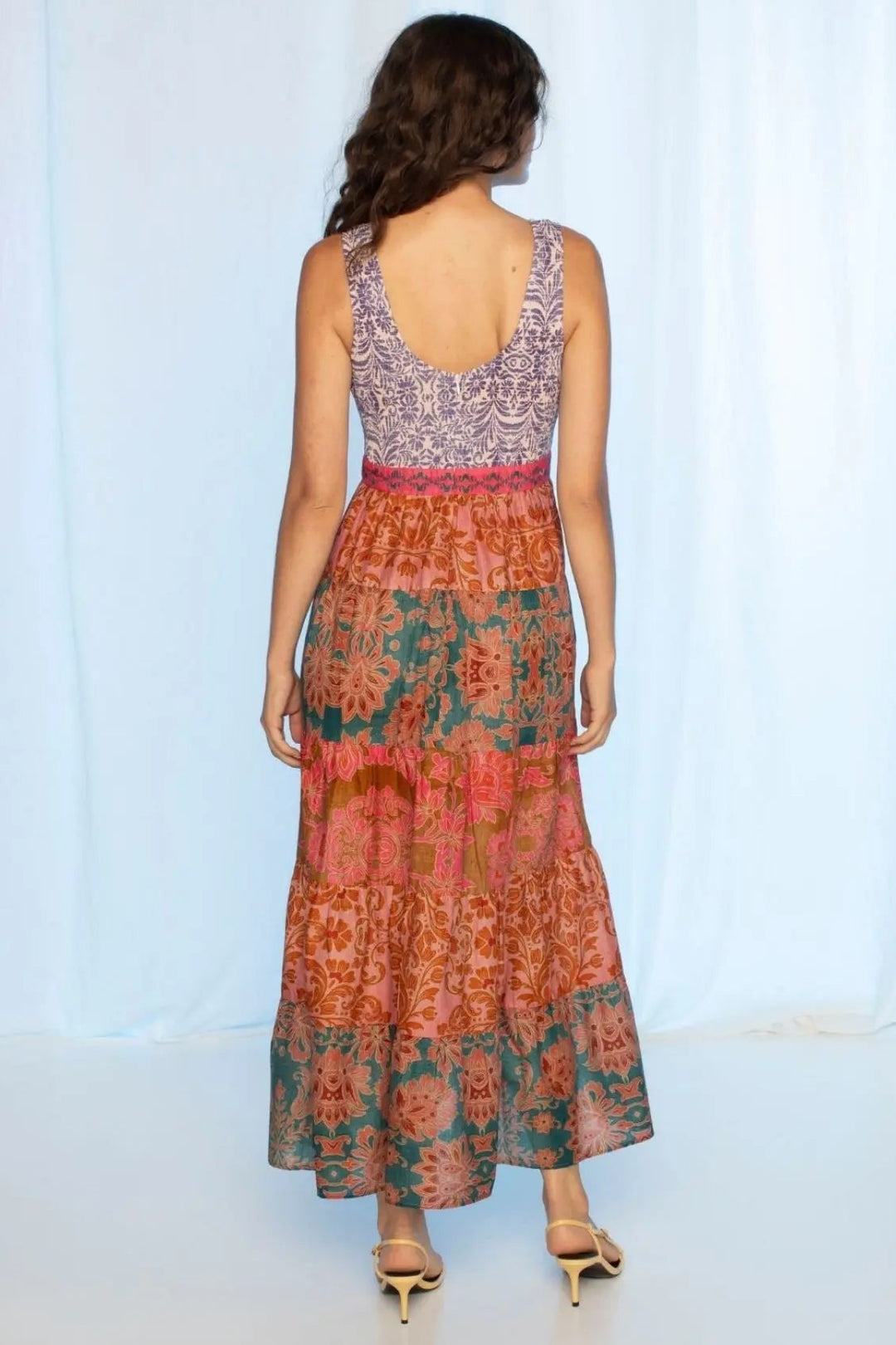Woman wearing a colorful dress with a white background