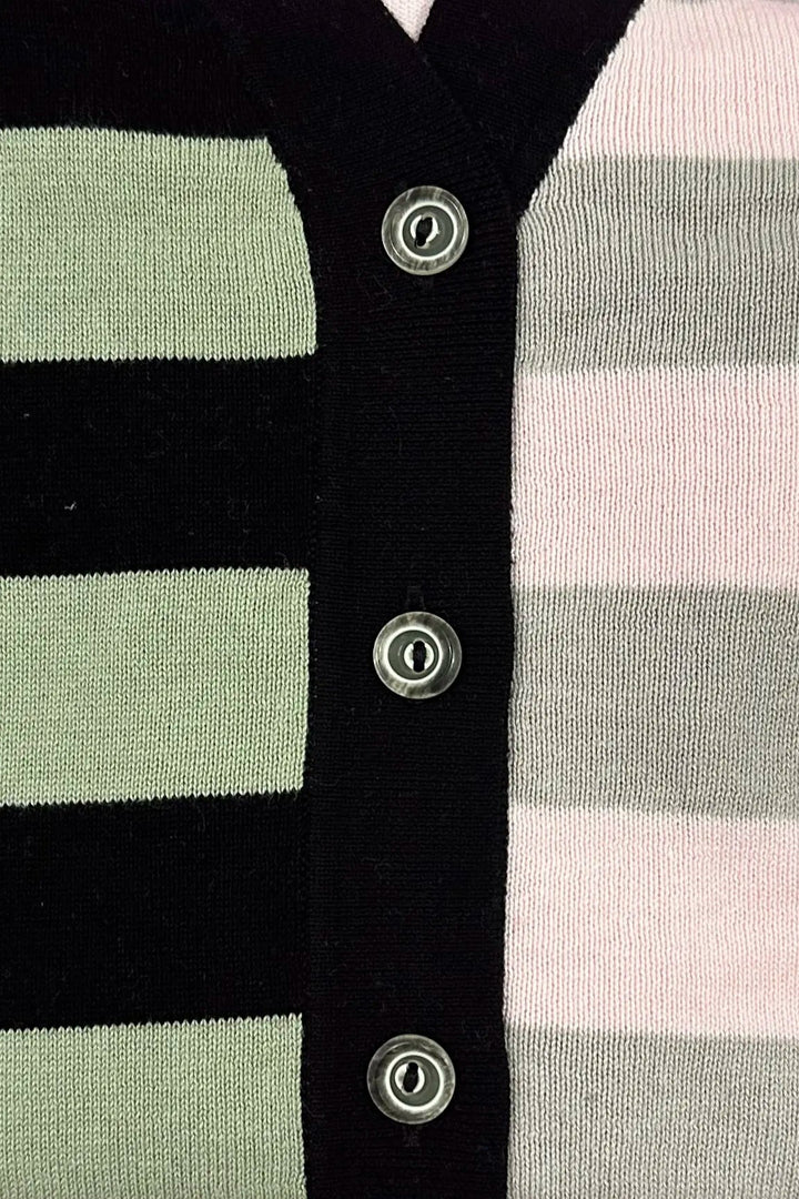 Close-up of a button down v-neck cardigan with emerald, grey, and pink stripes on a black background.