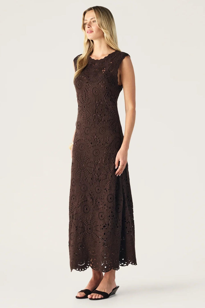 Woman wearing a brown lace dress on a white background
