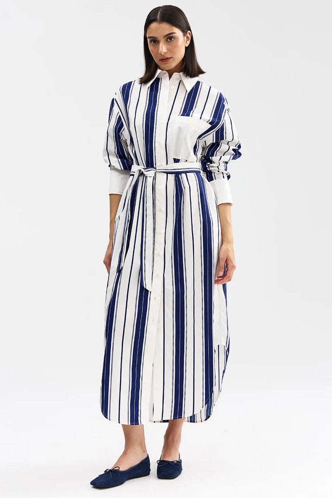 Woman wearing a white and blue striped dress on a white background