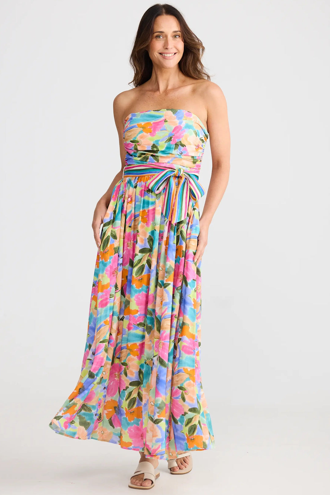 Woman wearing a colorful strapless dress on a white background
