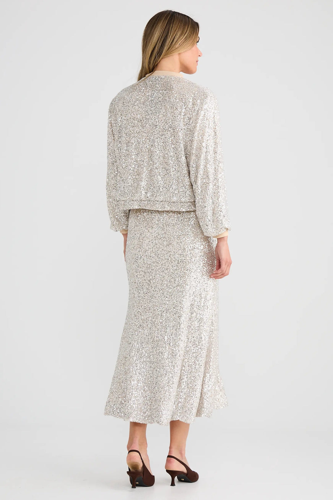 Woman wearing a matching top and skirt set on a white background