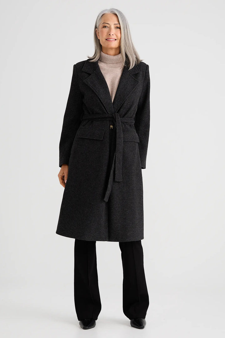 Woman wearing a dark gray coat on a white background