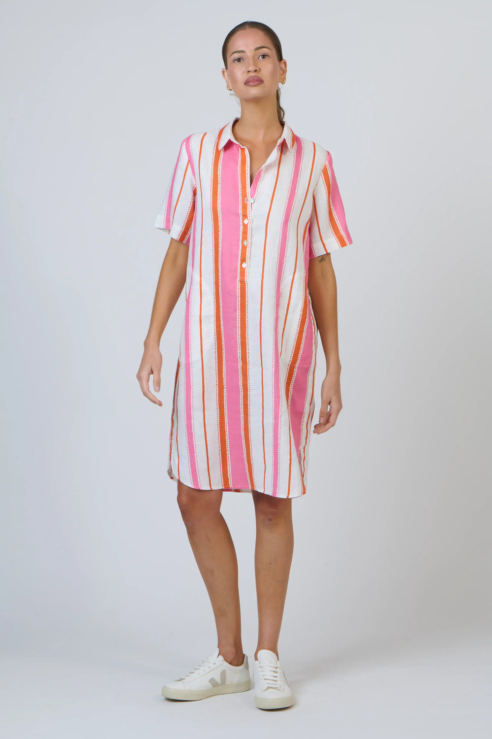 Woman wearing a striped shirt dress on a white background