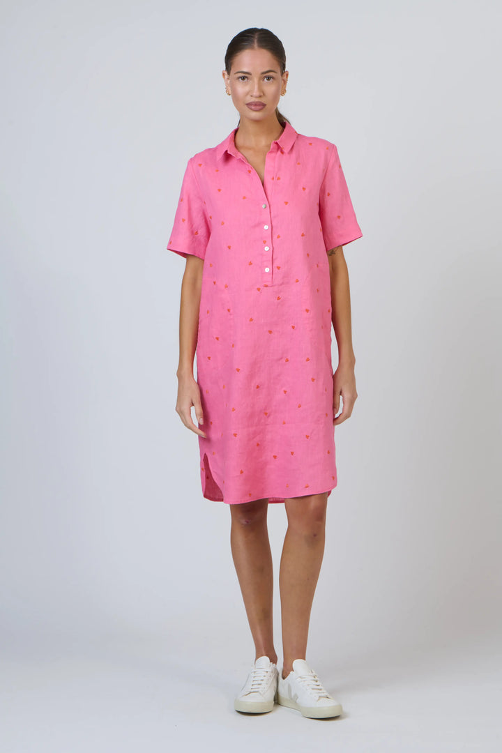 Woman wearing a pink dress with a white background