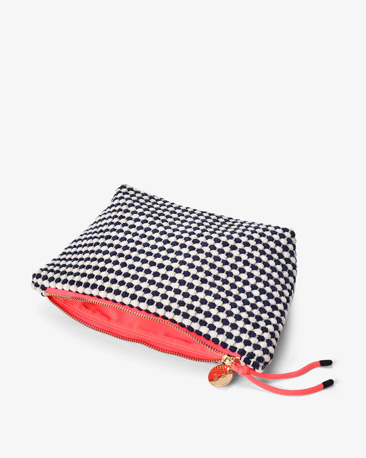 Small pouch with black and white polka dot pattern and pink interior on a white background. Elms & King Napili Large Navy White