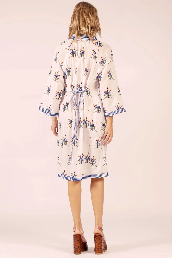 Woman wearing a floral dress with a plain background