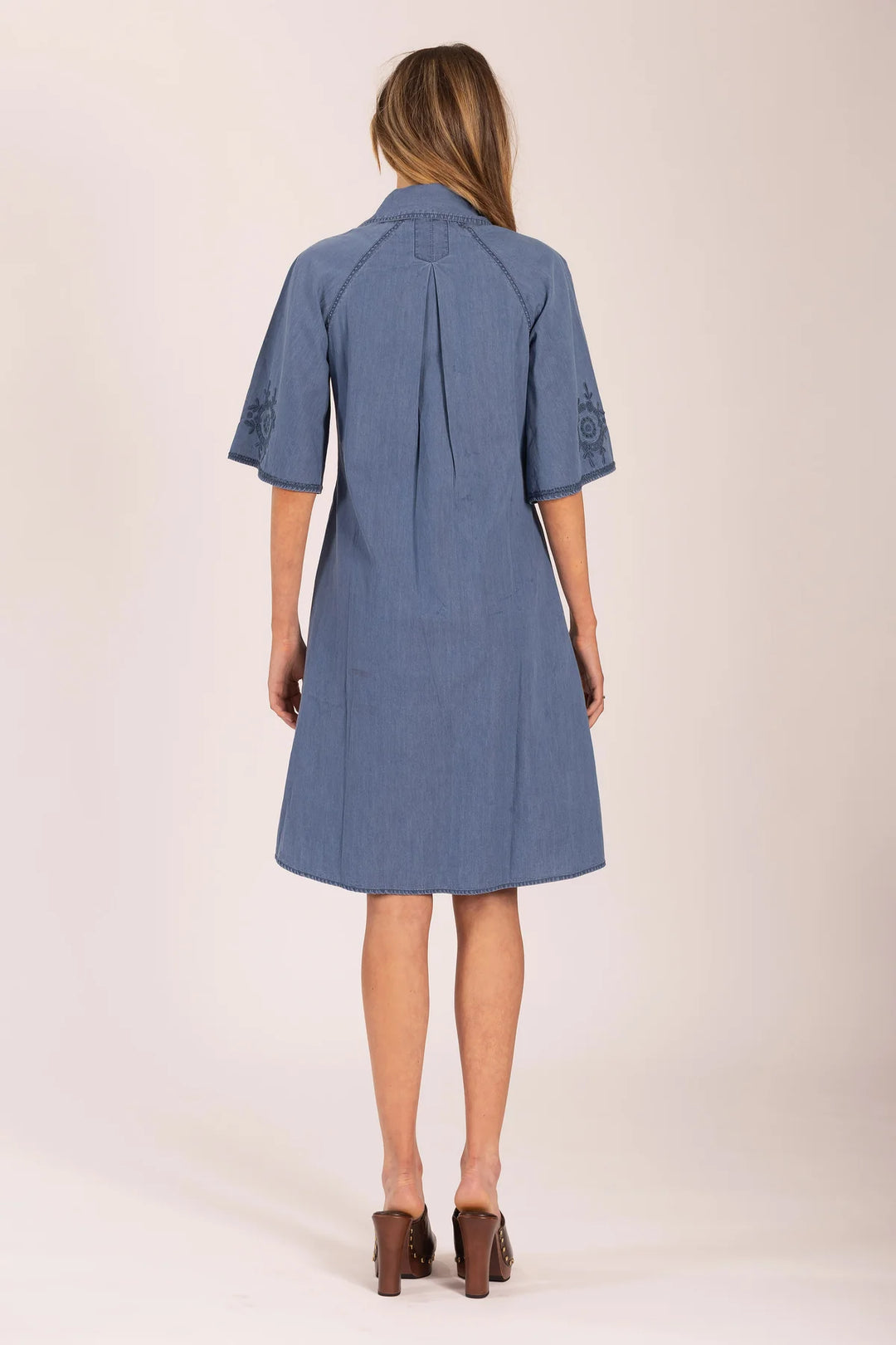 Woman wearing a blue dress on a white background