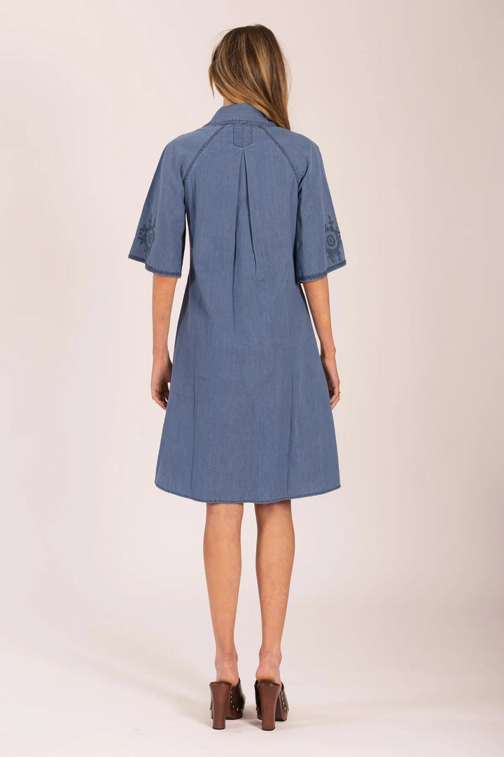 Woman wearing a blue dress on a white background
