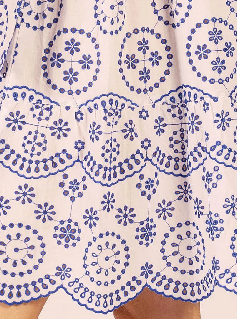 Close-up of a white dress with blue floral patterns