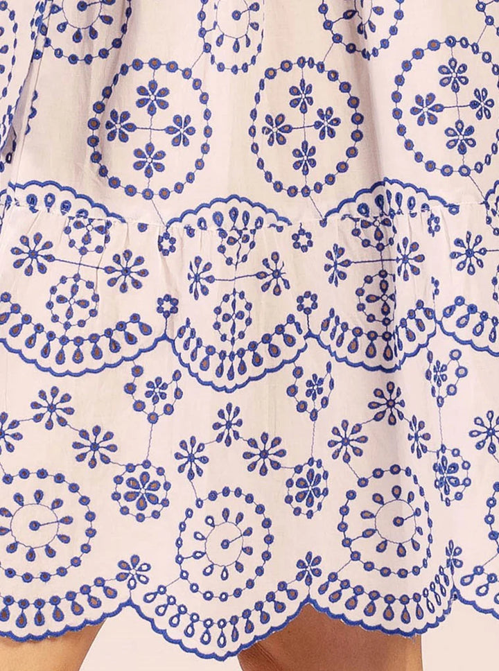 Close-up of a white dress with blue floral patterns