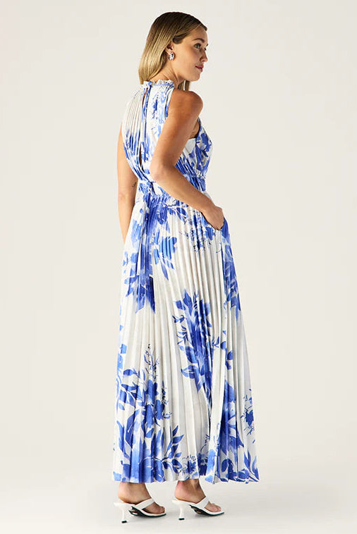 Woman wearing a blue and white floral dress on a white background