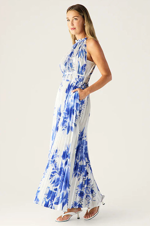 Woman wearing a blue and white patterned dress on a white background