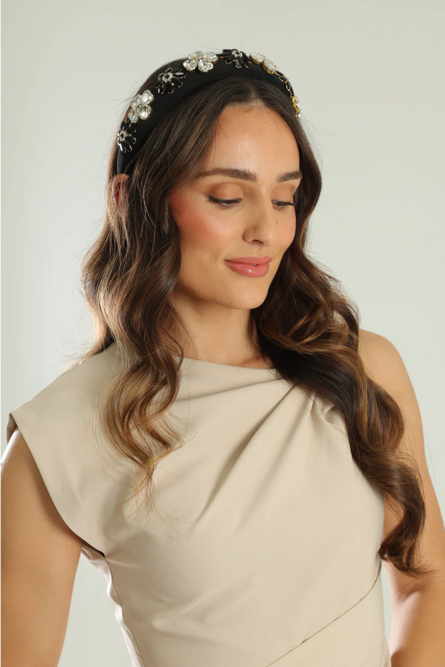Woman wearing a decorative headband with a plain background