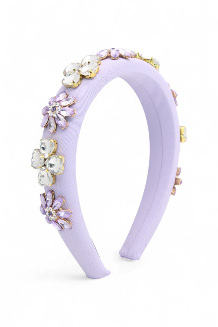 Lavender headband with floral embellishments on a white background