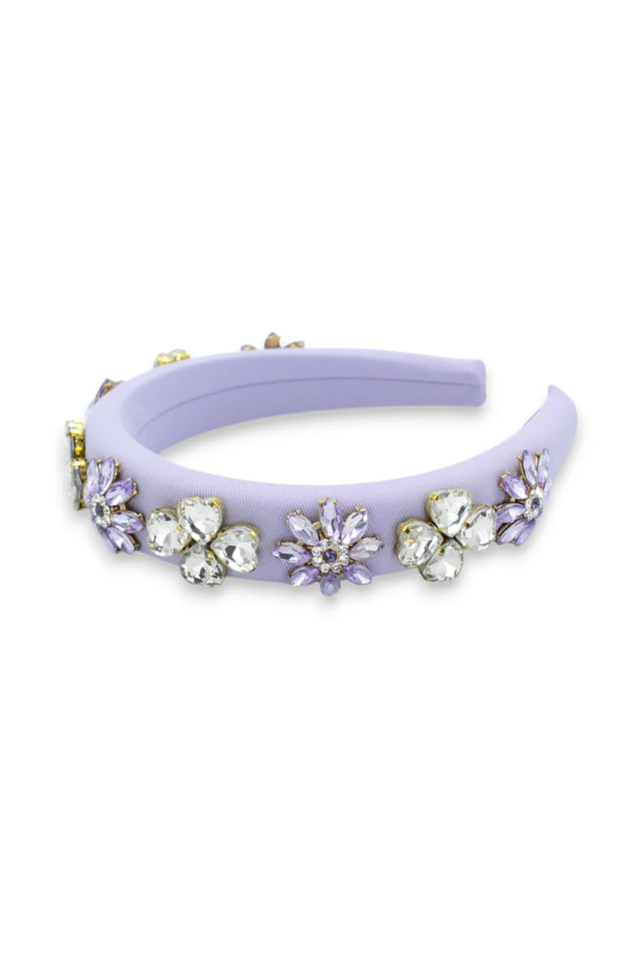 Lavender headband with floral embellishments on a white background