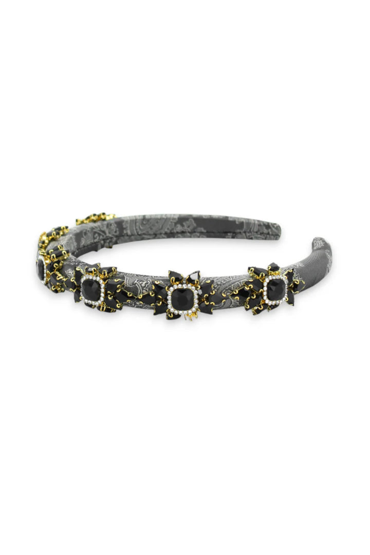 Decorative headband with black and gold accents on a white background