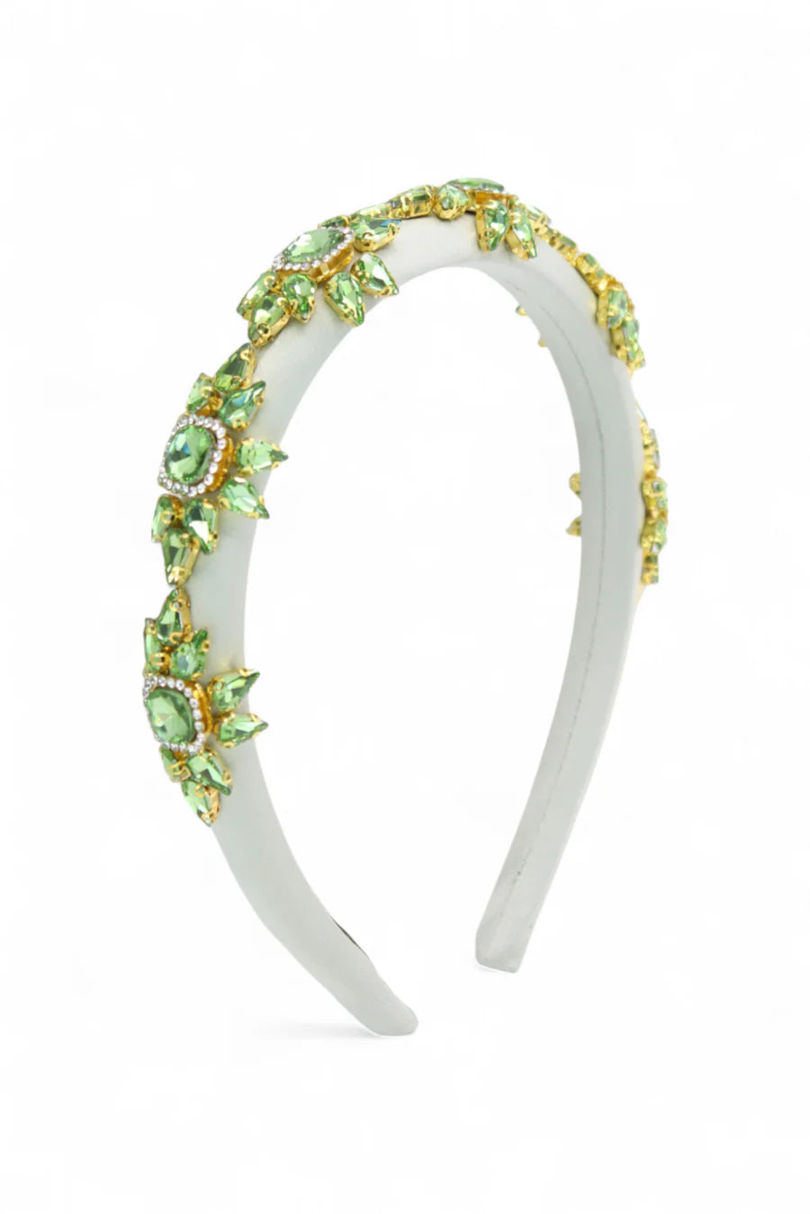 White headband with green gemstones on a white background