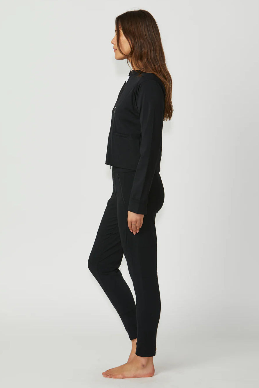 Person wearing a black outfit on a white background