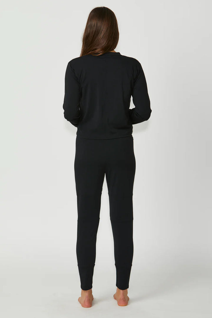 Person wearing a black outfit on a white background