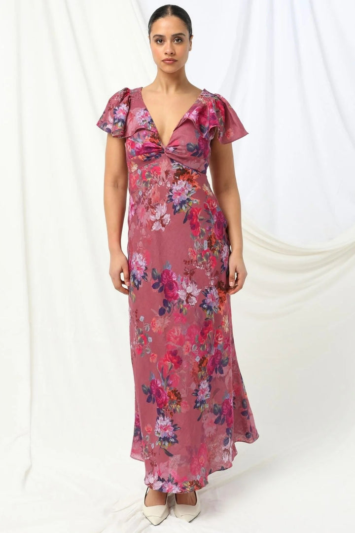 Woman wearing a pink floral dress on a white background