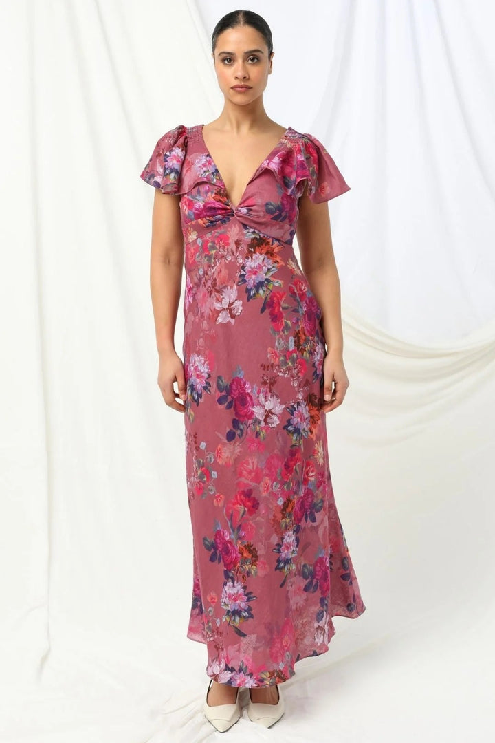 Woman wearing a pink floral dress on a white background