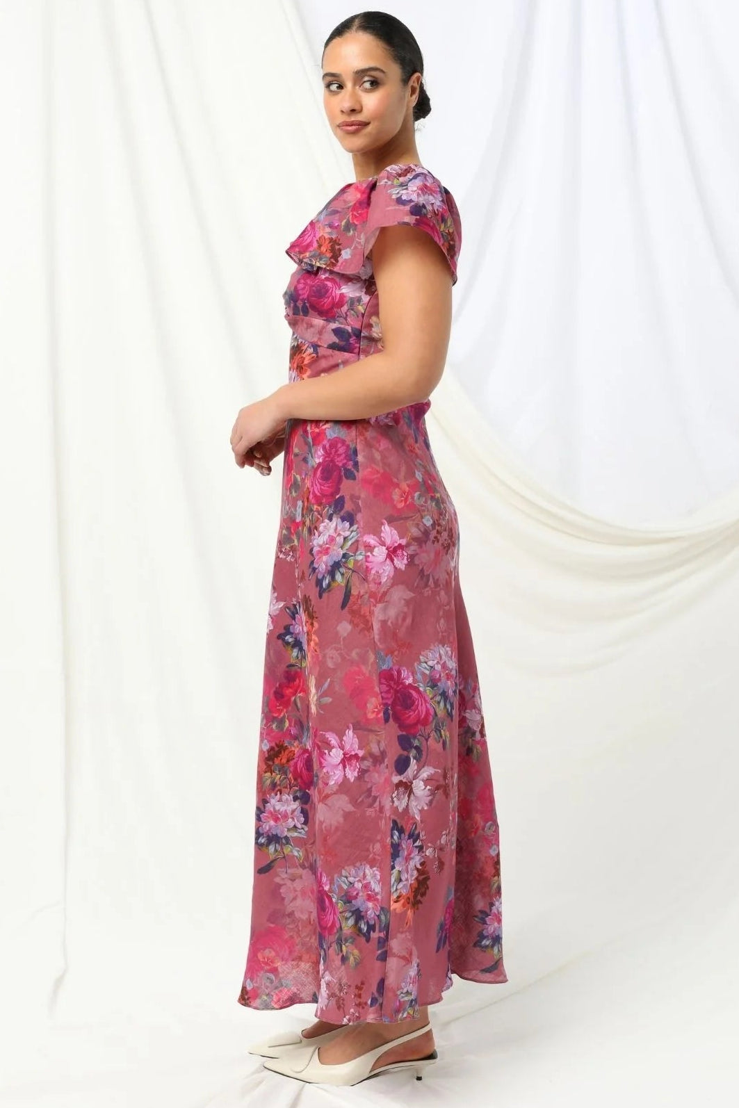 Woman wearing a pink floral dress on a white background