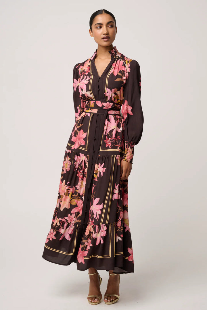 Woman wearing a floral dress with a belt on a white background