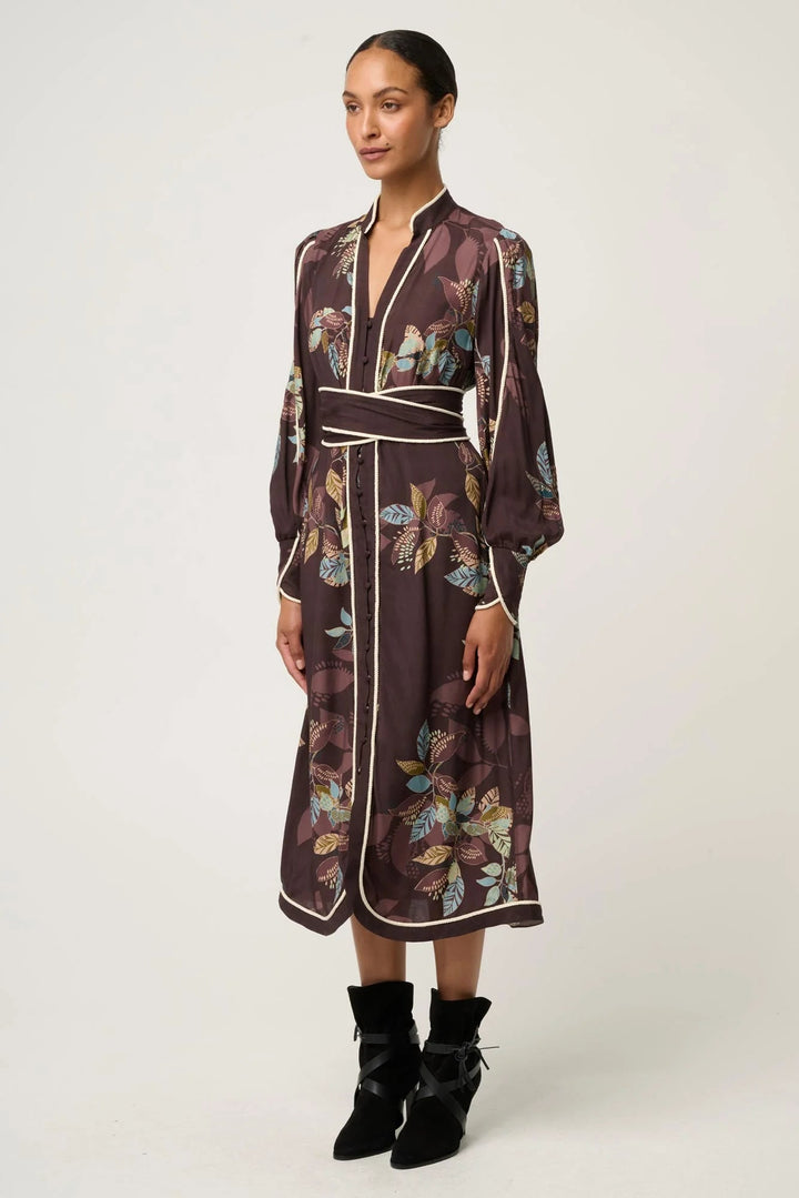 Woman wearing a floral patterned dress with a white background