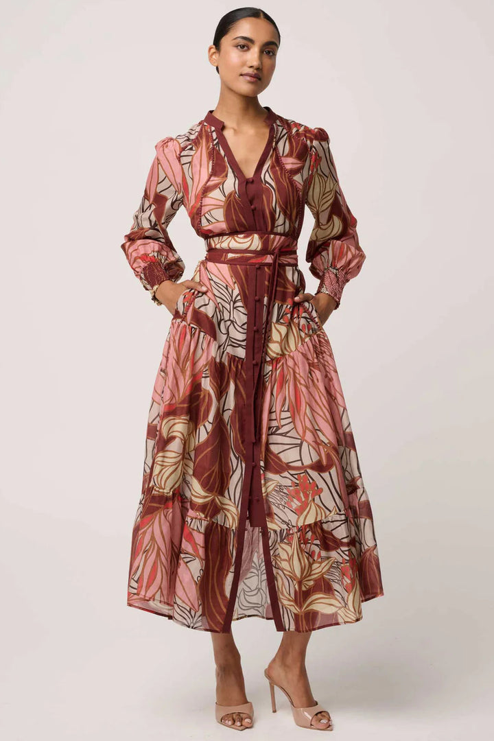 Woman wearing a patterned dress on a white background
