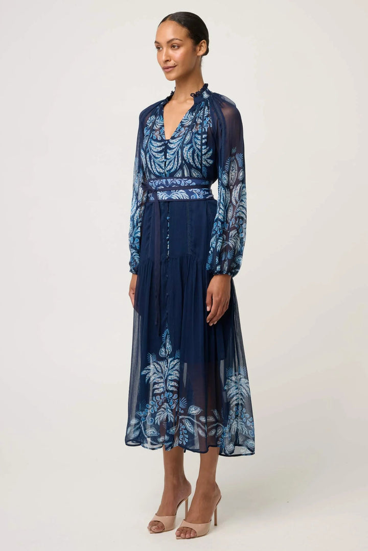 Woman wearing a blue floral dress on a white background