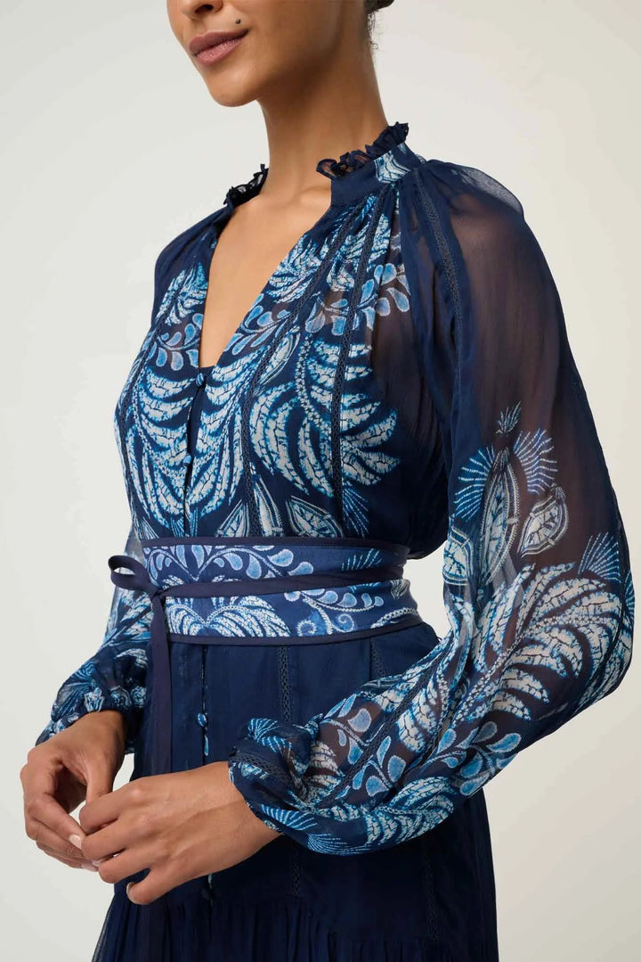 Navy blue dress with intricate white floral patterns on a plain background
