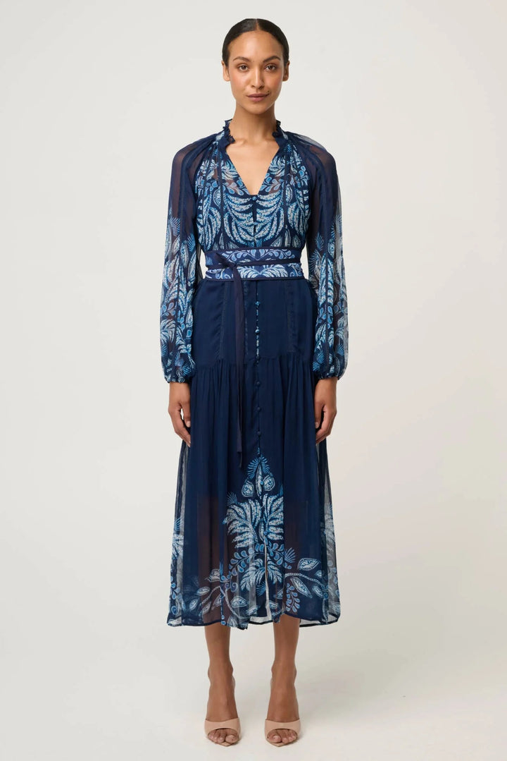 Woman wearing a blue floral dress on a white background