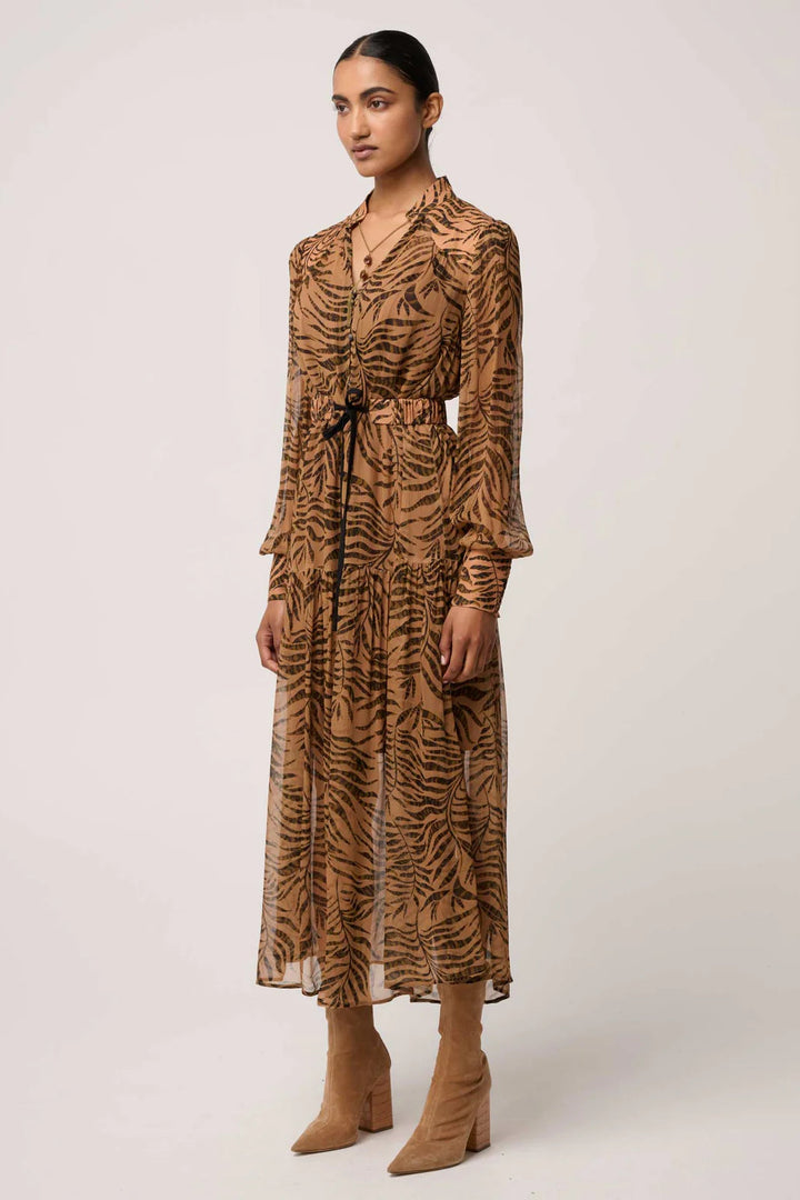 Woman wearing a brown tiger-striped dress on a white background