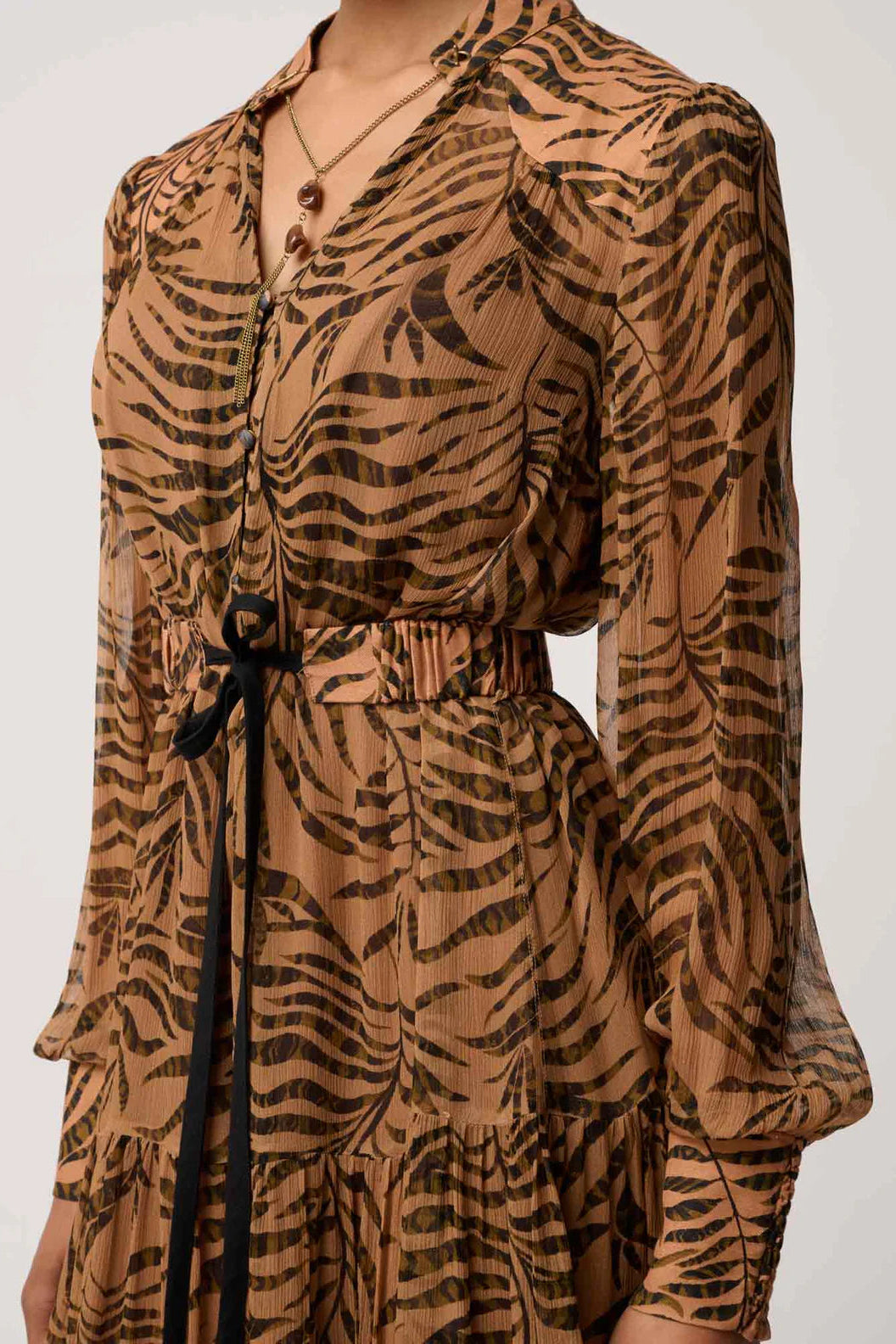 Brown dress with black animal print pattern on a white background