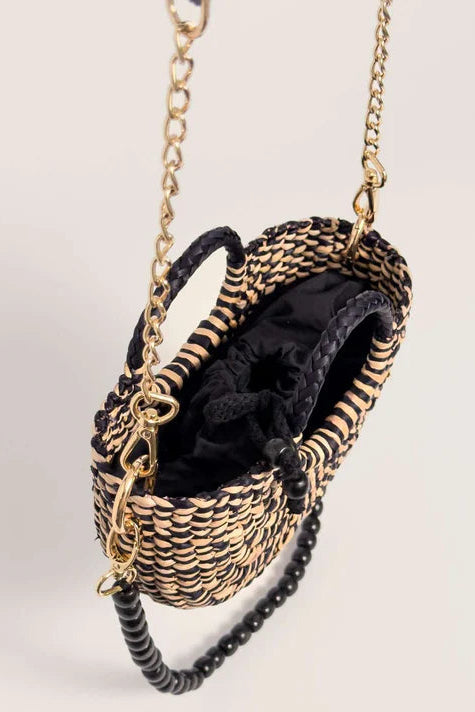 Black and gold handbag with chain strap on a light gray background. Orange Inca The New Mini Fiesta Bag Marbled Black