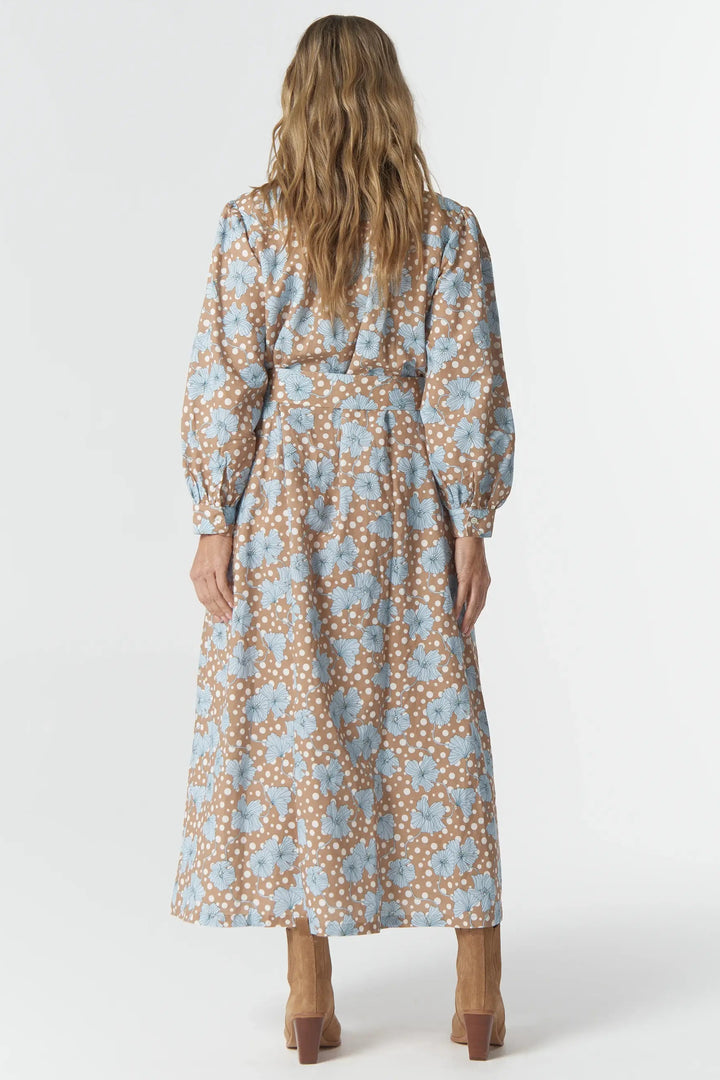 Woman wearing a floral dress from behind on a white background