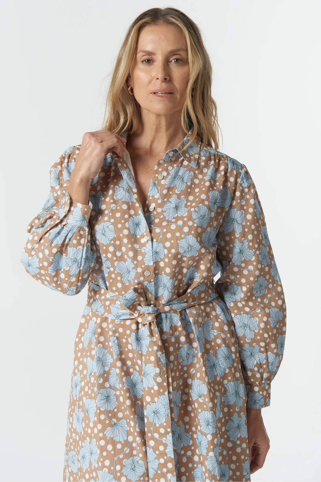Woman wearing a floral patterned dress on a white background