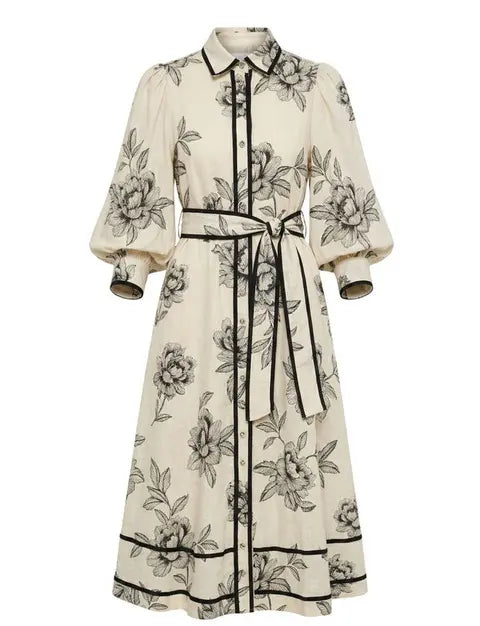 White dress with black floral pattern on a white background