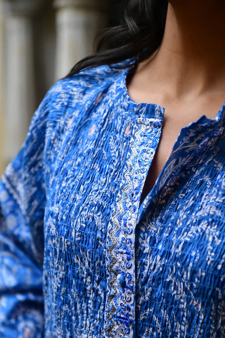 Close-up of a blue patterned blouse with a blurred background