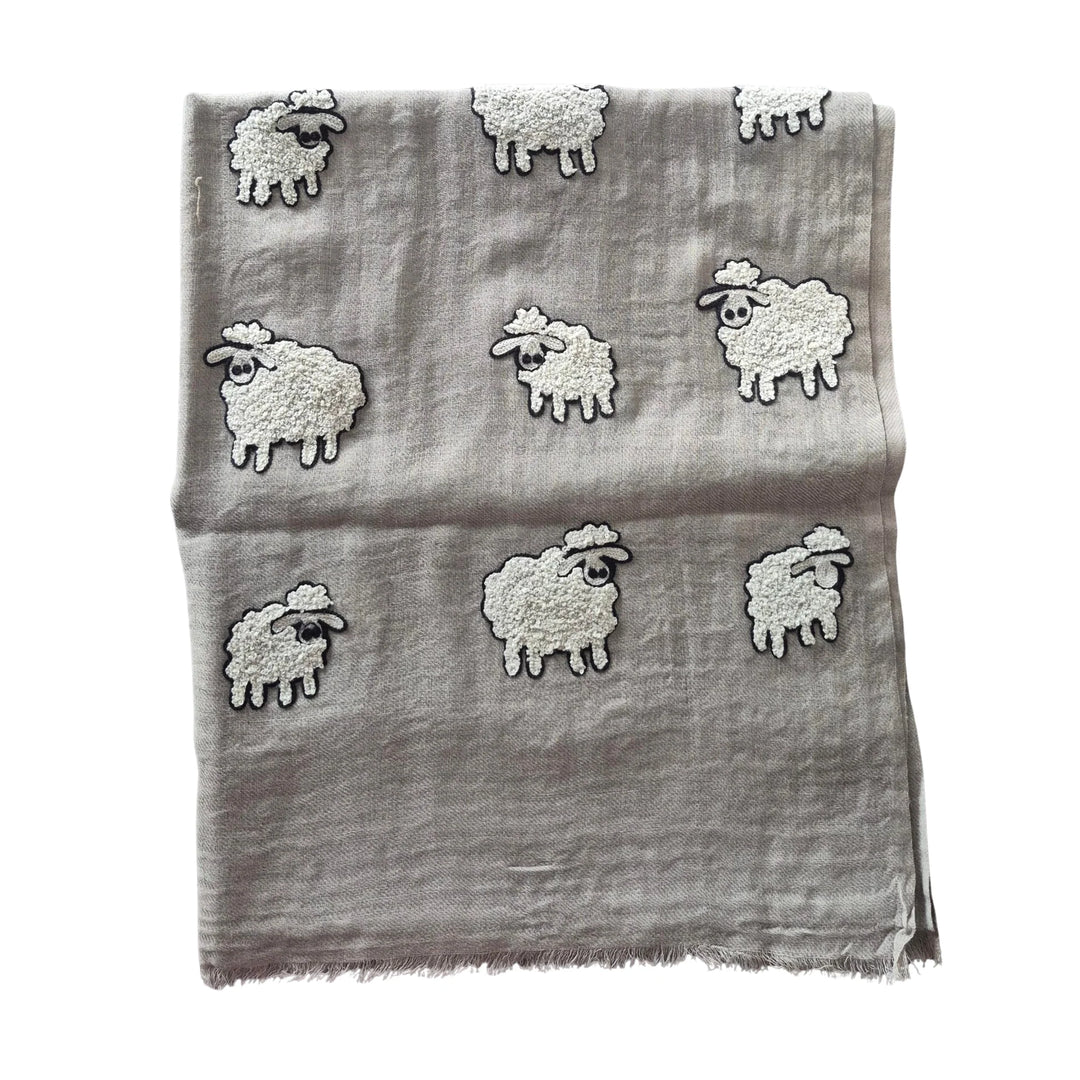 Gray scarf with embroidered sheep designs on a white background