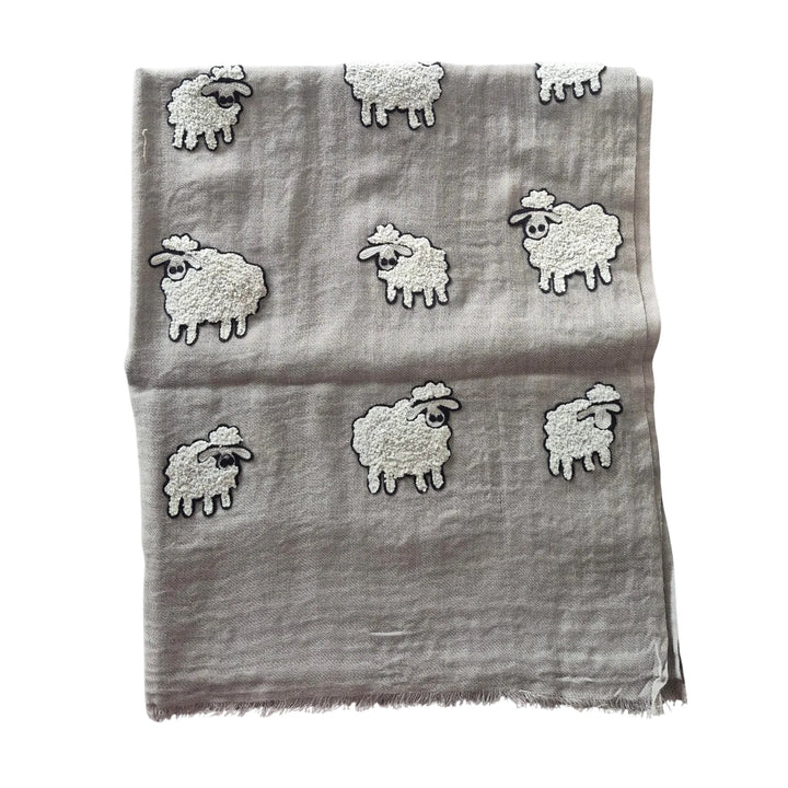 Gray scarf with embroidered sheep designs on a white background