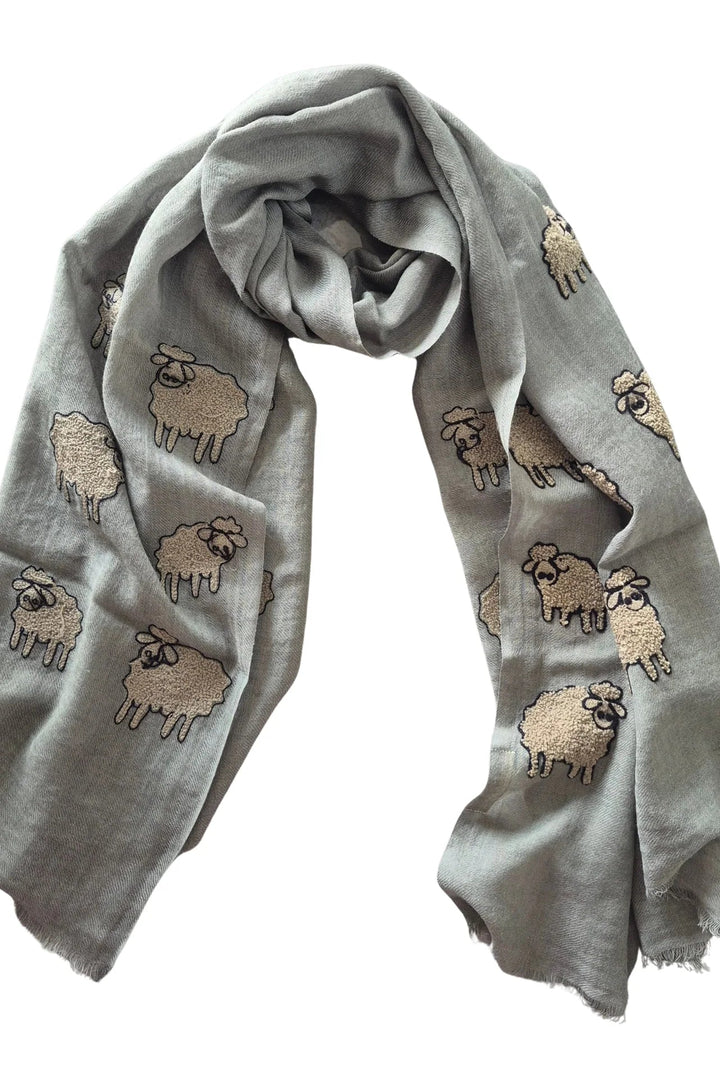 Gray scarf with embroidered sheep patterns on a white background