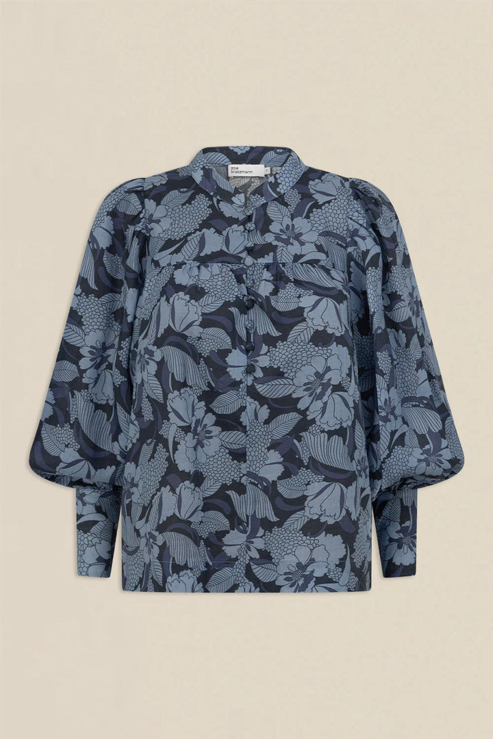 Blue floral patterned blouse on a beige background
